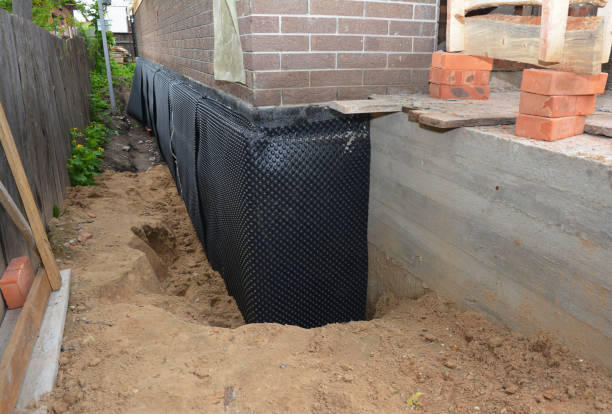 Happy homeowners after waterproofing job in Tiro